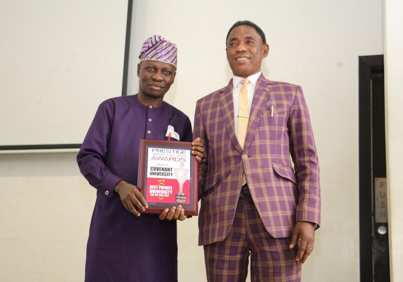 Dean Student Affairs Professor David Imhonopir Receiving The Award From Mr Obiola Of Prestige Awards