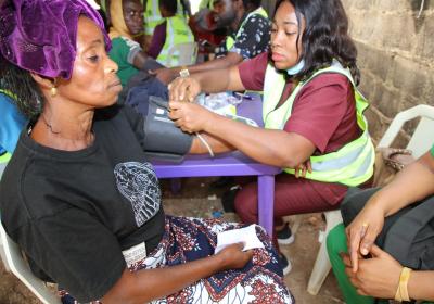 Another Member Of Cucdiic Checking The Blood Pressure Of One Of The Obere Women